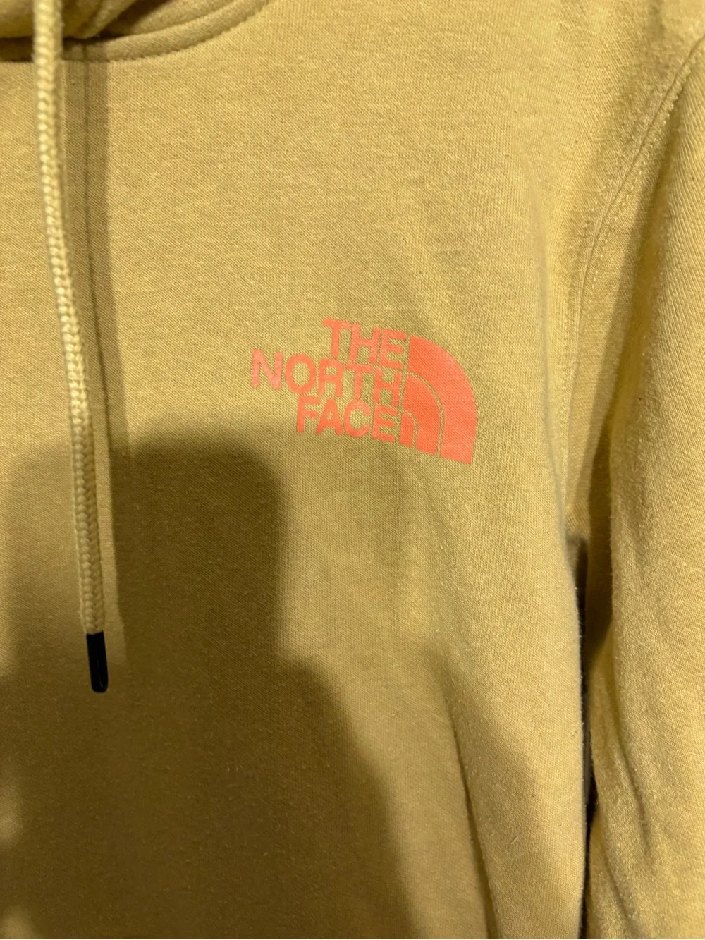 The North Face Mustard Pullover Hoodie with mountain outdoors scenery